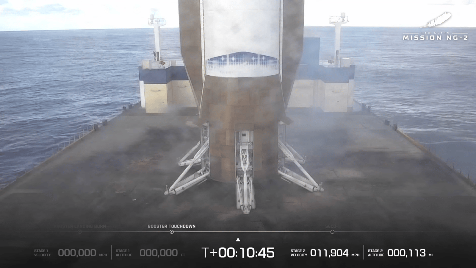 a large white-and-blue rocket stands upright on a boat at sea