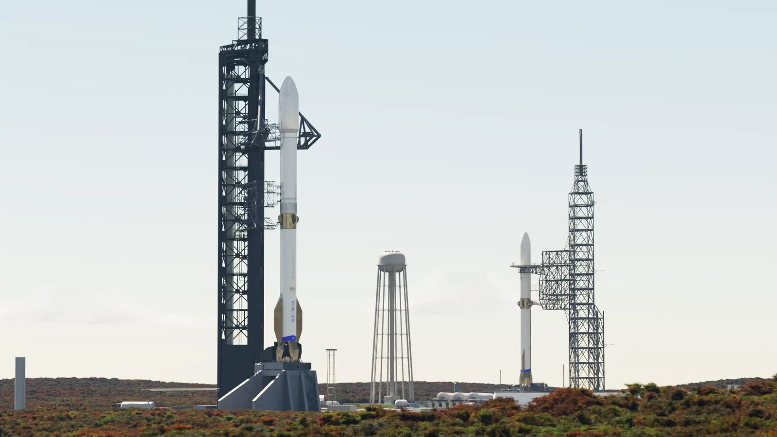 Two rockets stand at neighboring launch towers.