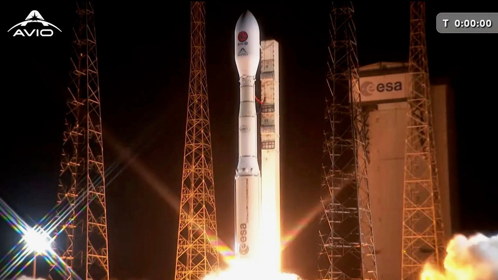 a white rocket launches into a dark night sky