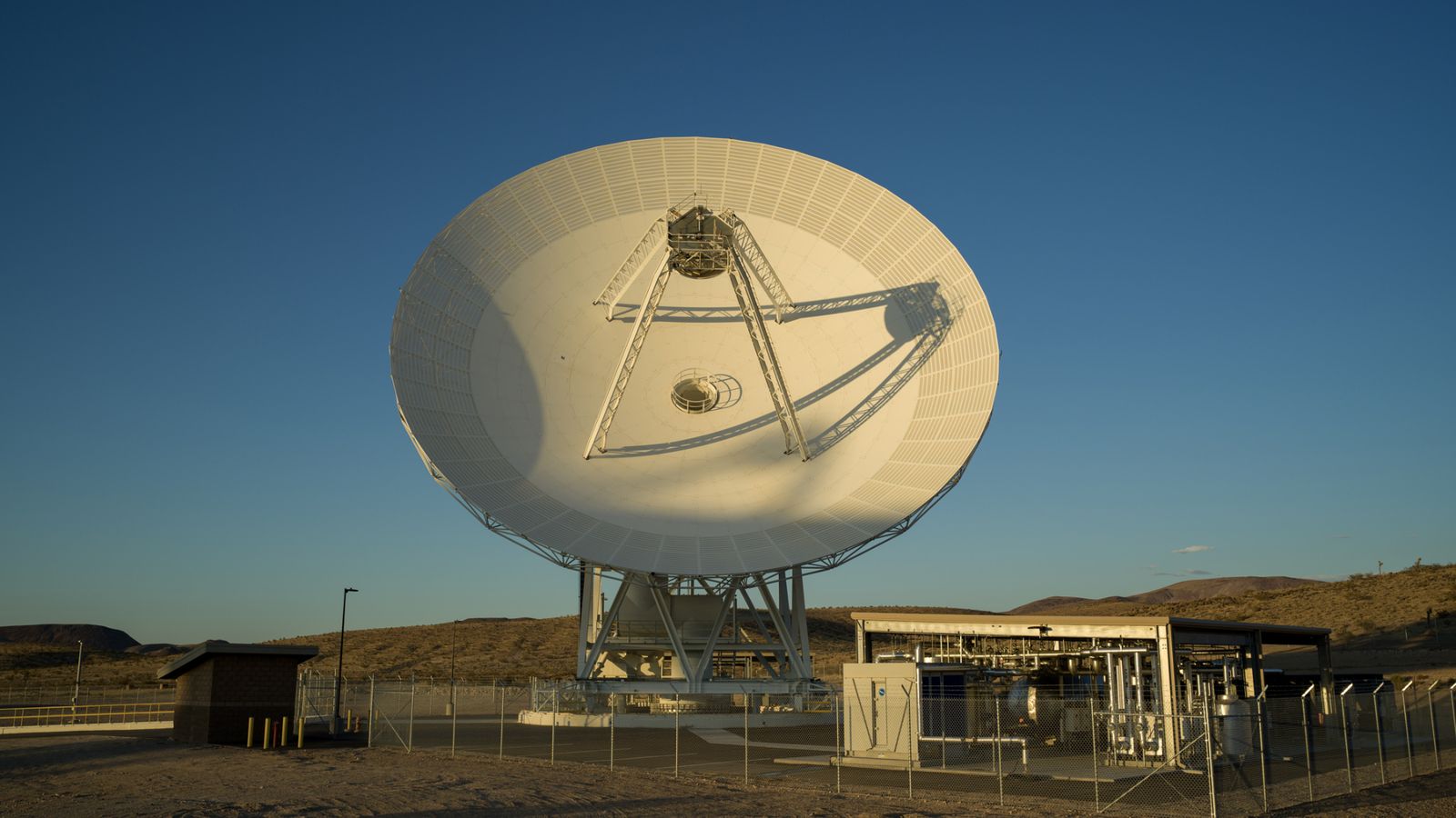 a large dish points towards the sky.