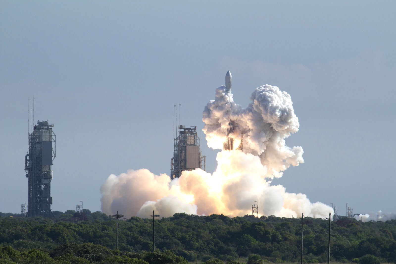A rocket launches and is engulfed in exhaust