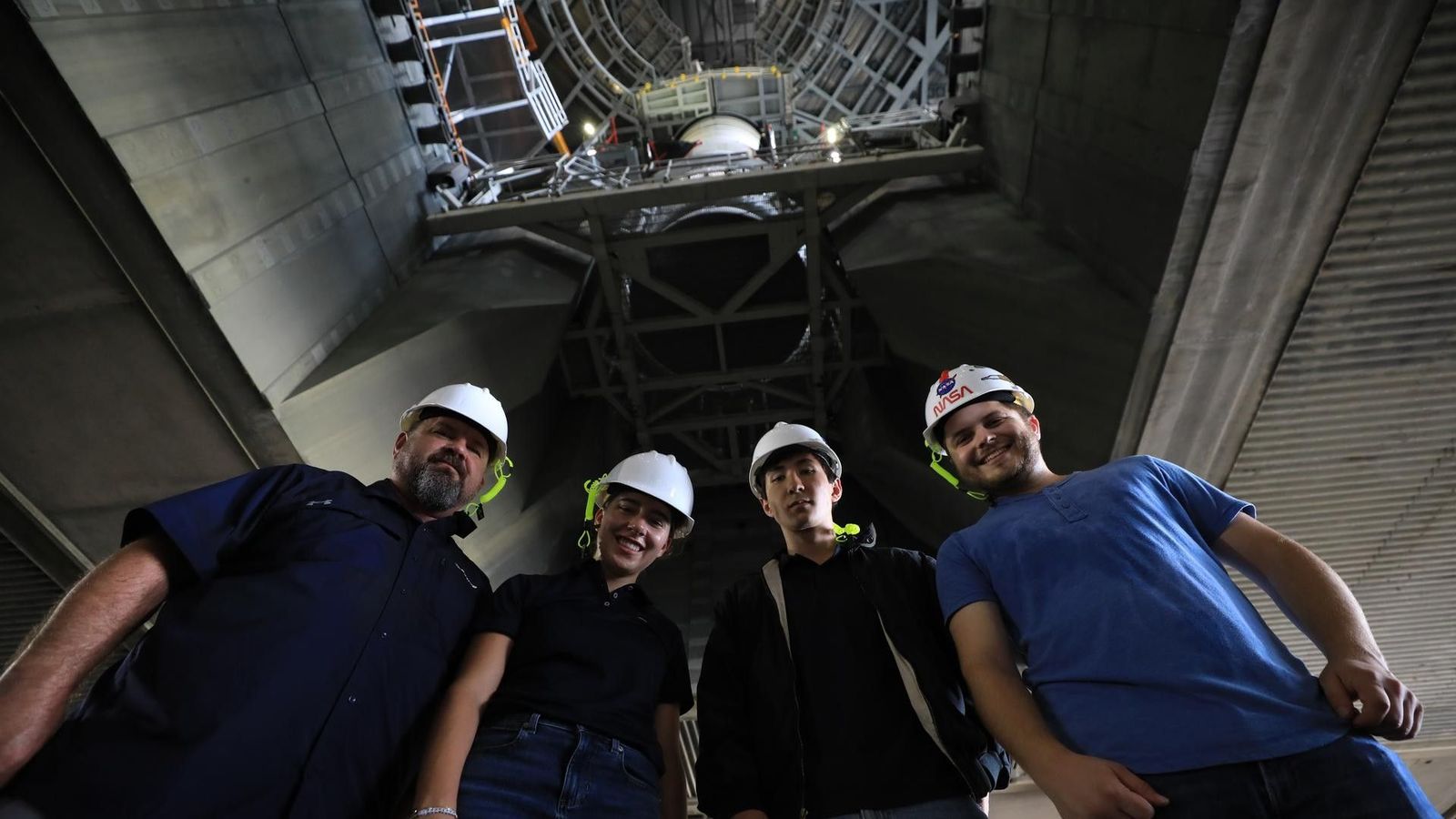 Employees pose for a photograph following work inside the VAB to secure the left-hand aft assembly solid rocket booster segment to the mobile launcher at the VAB on July 9, 2026.