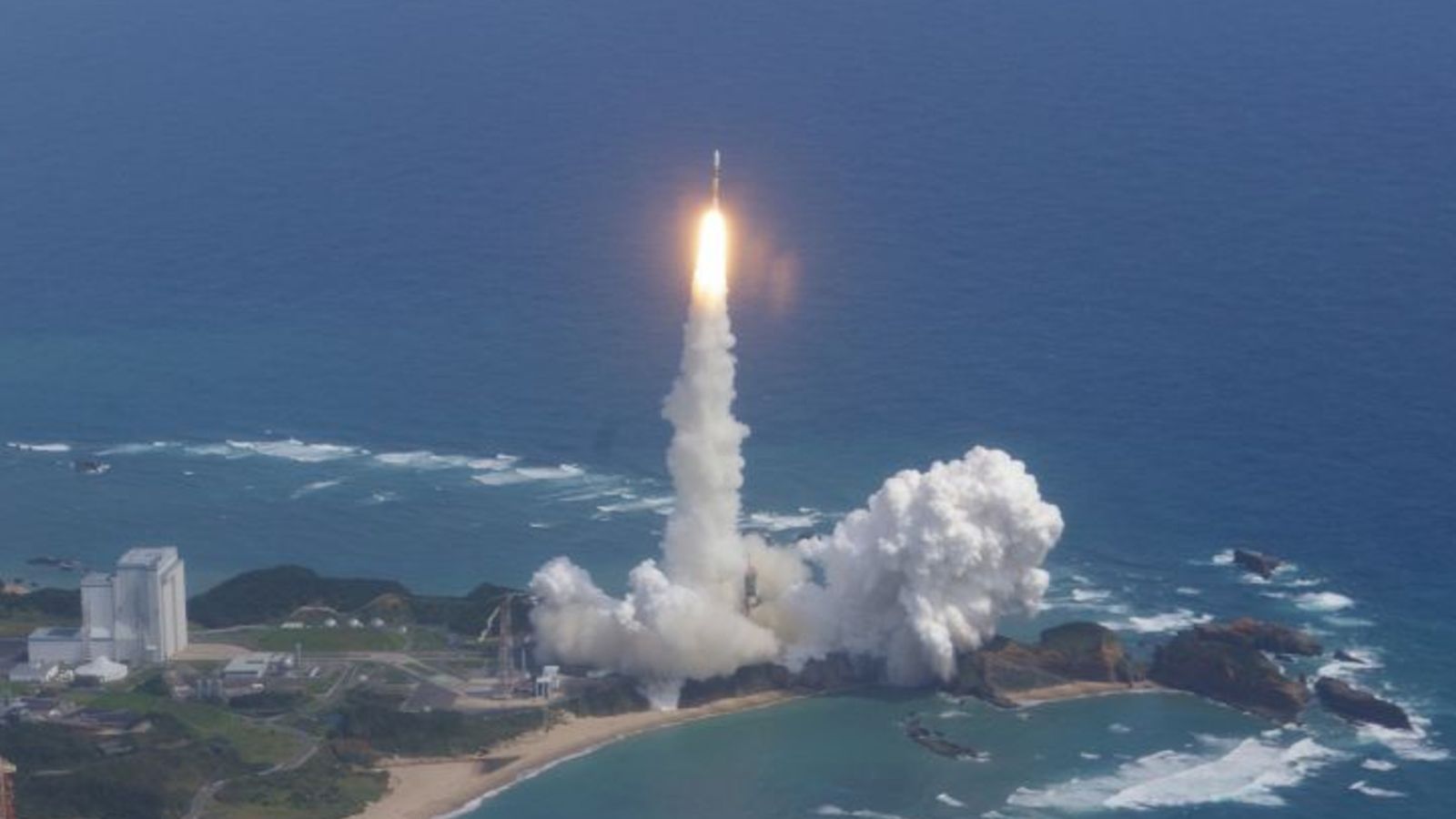 A white and yellow Japanese rocket launches the Kaguya spacecraft to the moon on Sept. 13, 2007.