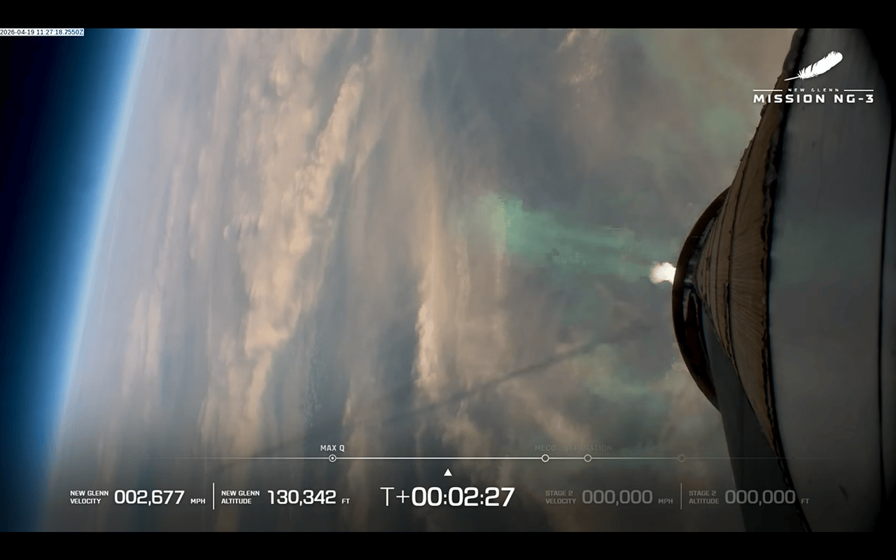 A view of Earth during the launch of Blue Origin's NG-New Glenn rocket as seen from the booster. The shadow of its exhaust plume is visible across the left side of the image.