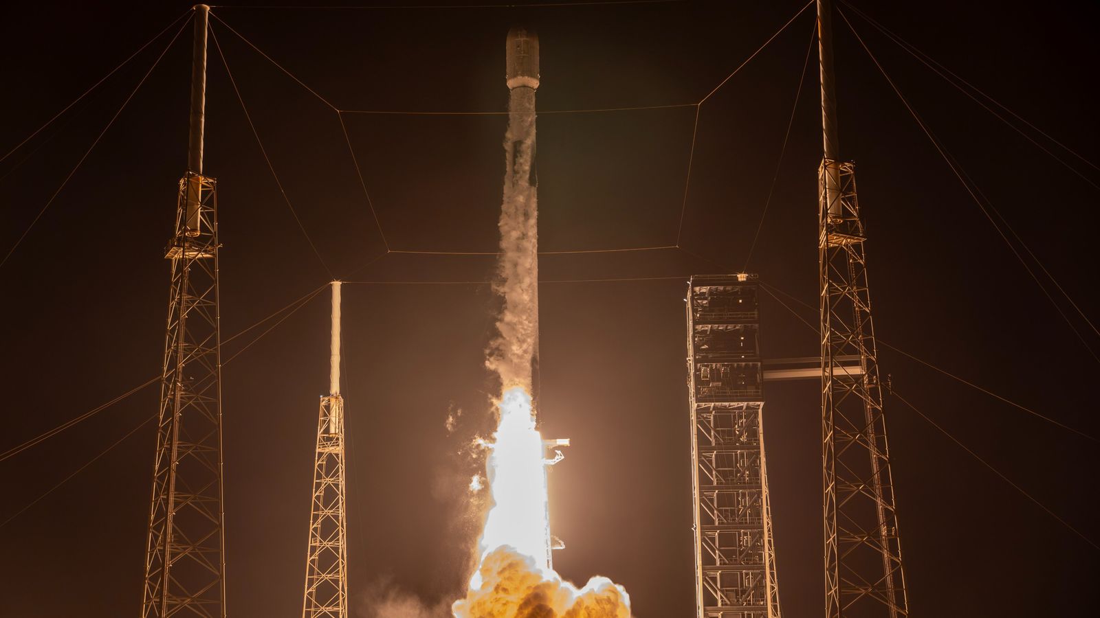 rocket launching from a launch pad at night