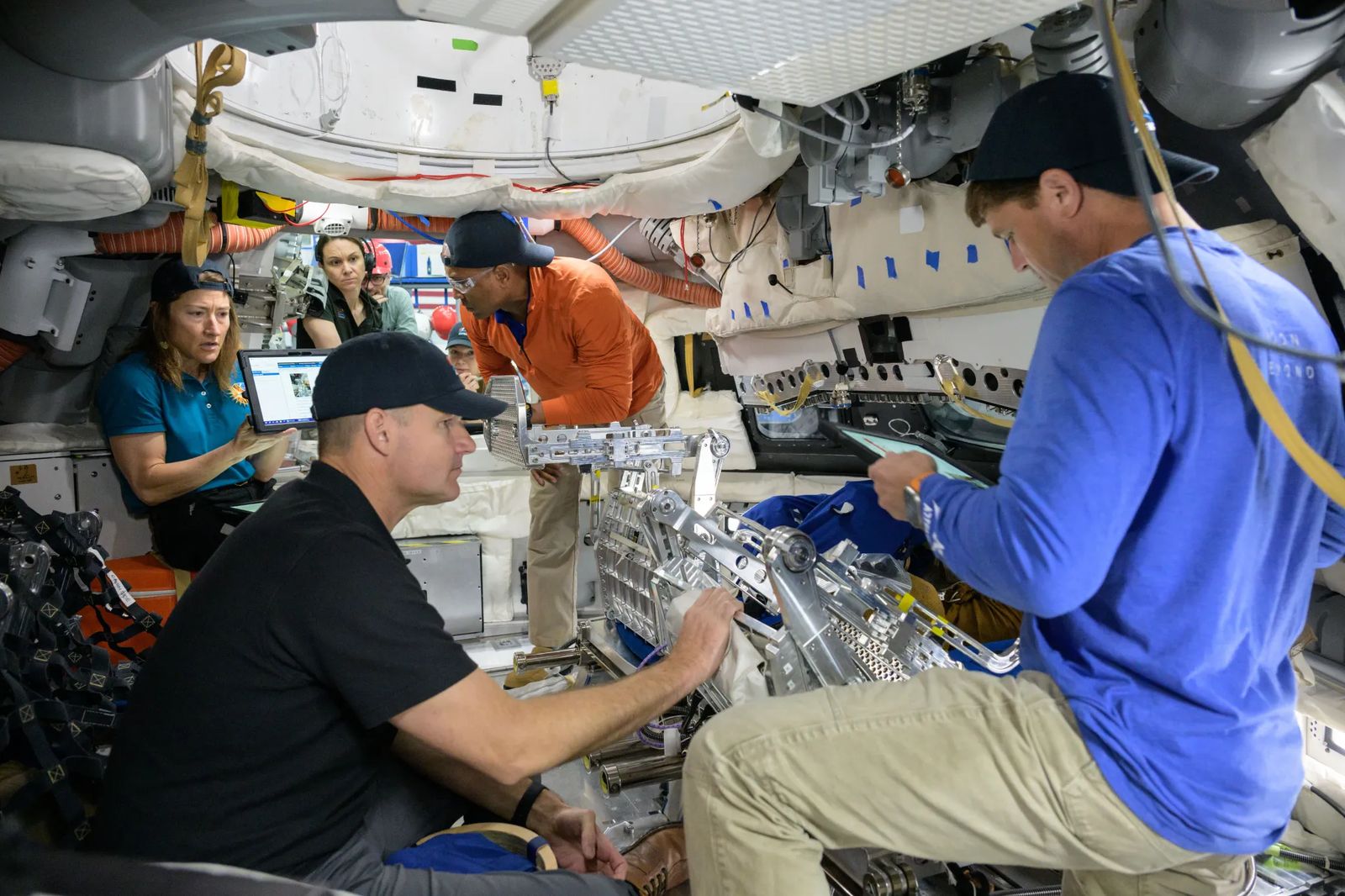 Artemis II Crew during "Day in the Life" training in Orion Medium Fidelity Mockup. Photo Date: May 2, 2024. Location: Building 9N, Orion Mockup. Photo Credit: NASA/Robert Markowitz