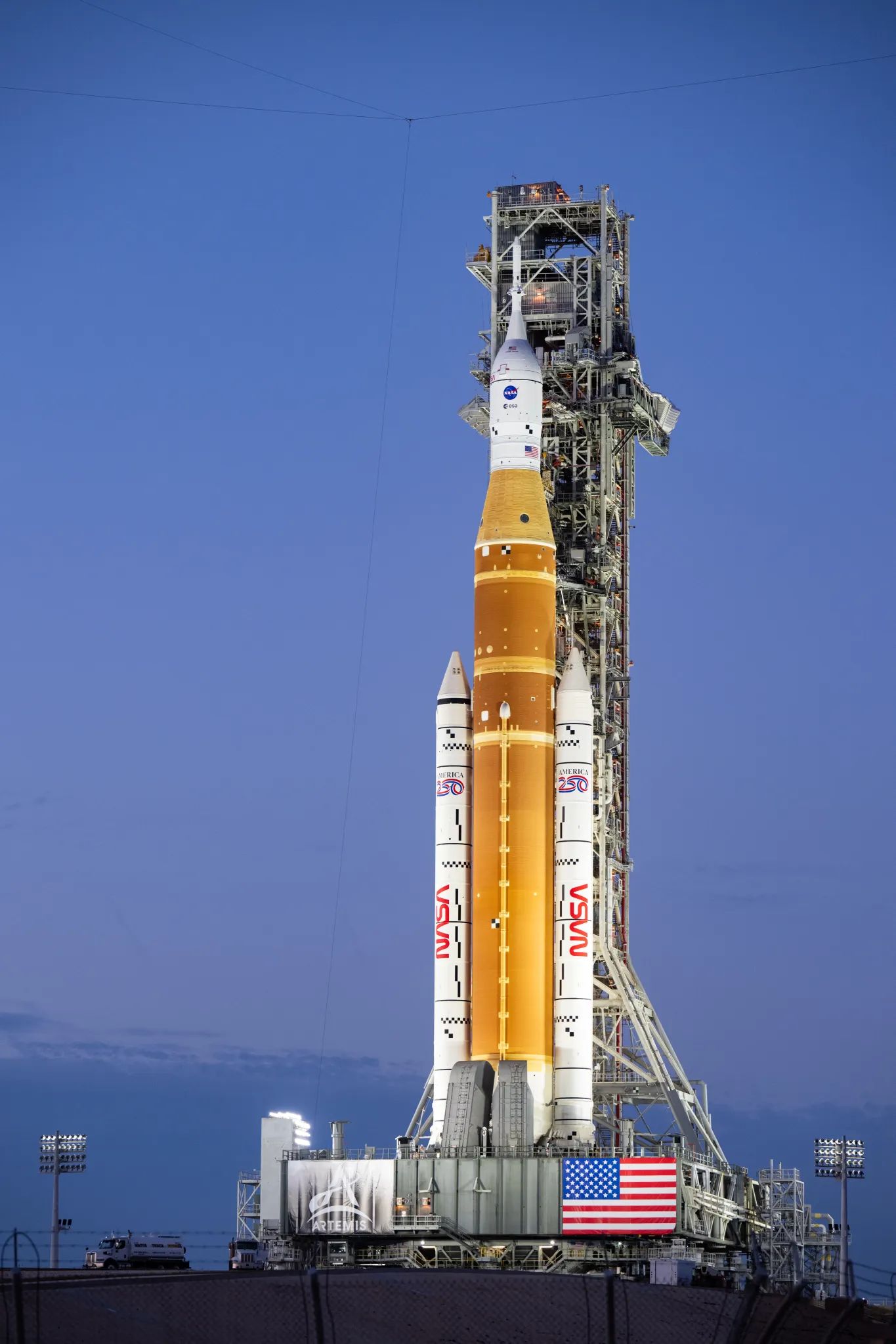 NASA's orange and white Space Launch System rocket on the launch pad.