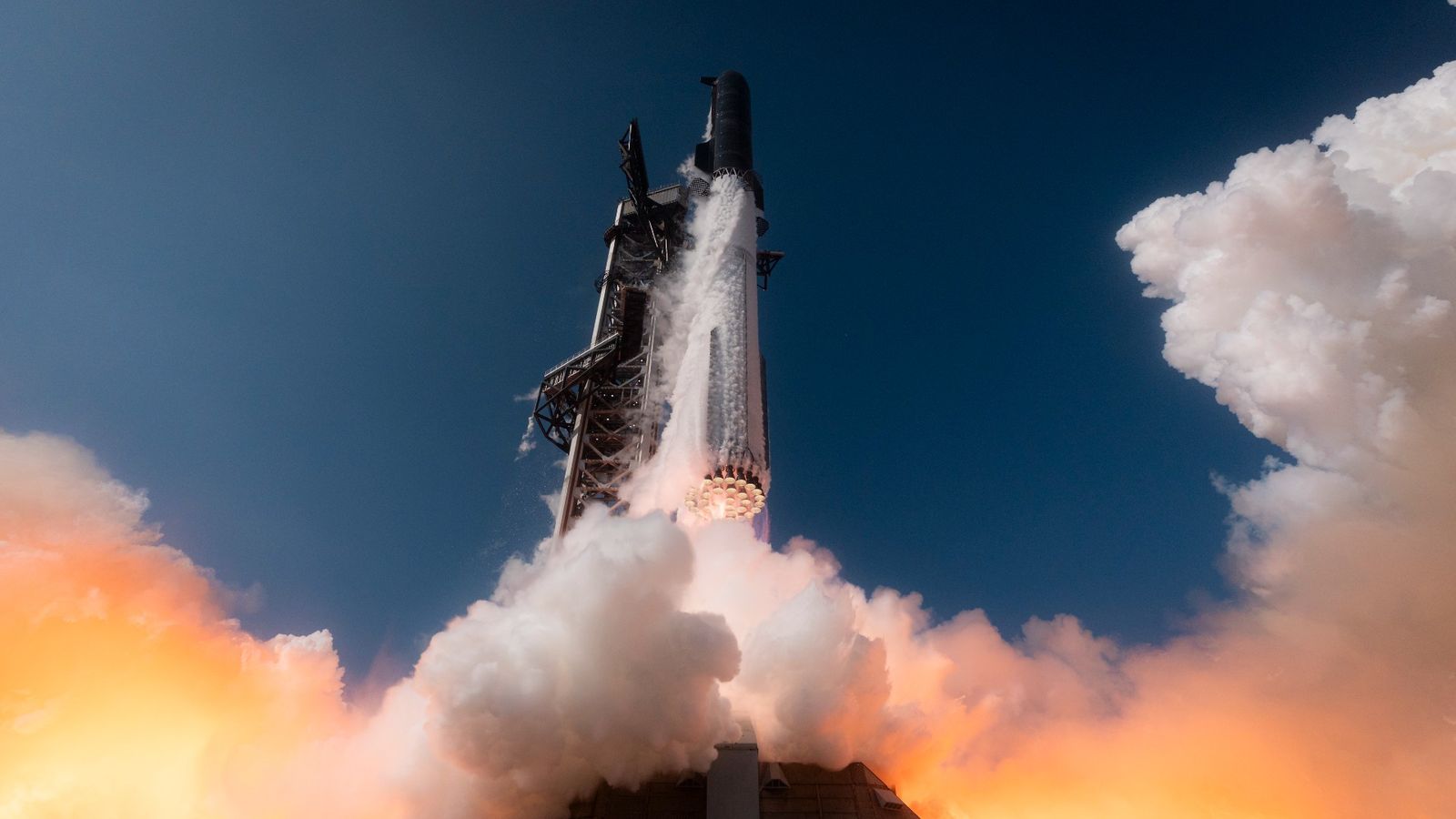 a large silver rocket launches above a plume of fire