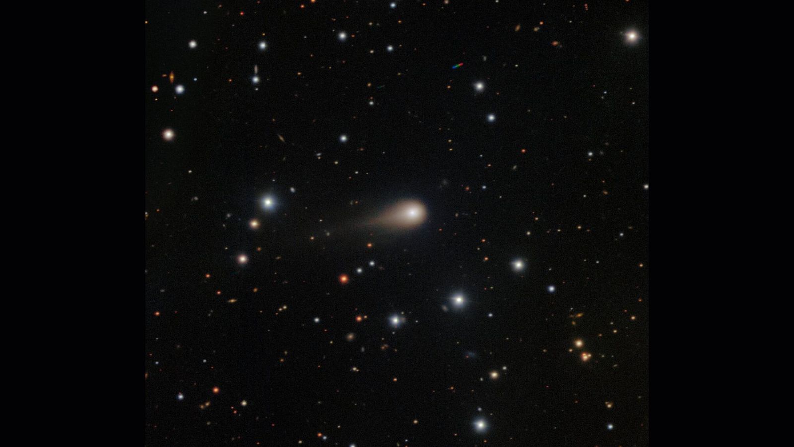 A streak of white shows interstellar comet 3I/ATLAS in the center of a starry night sky