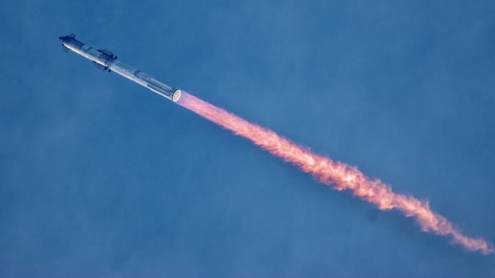 a giant rocket launches against a colorful sky
