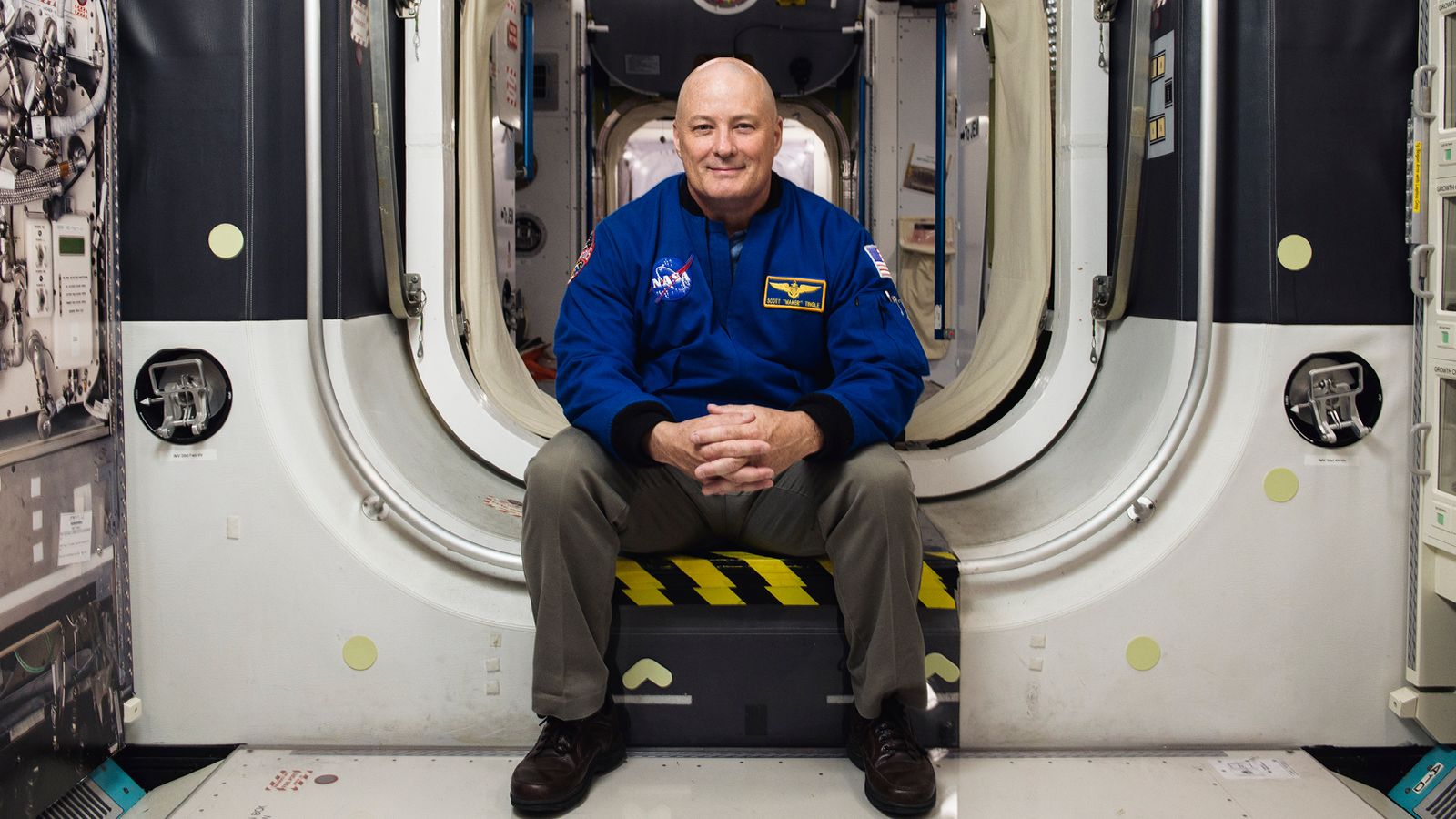 Scott Tingle poses for a photo inside a module of the International Space Station