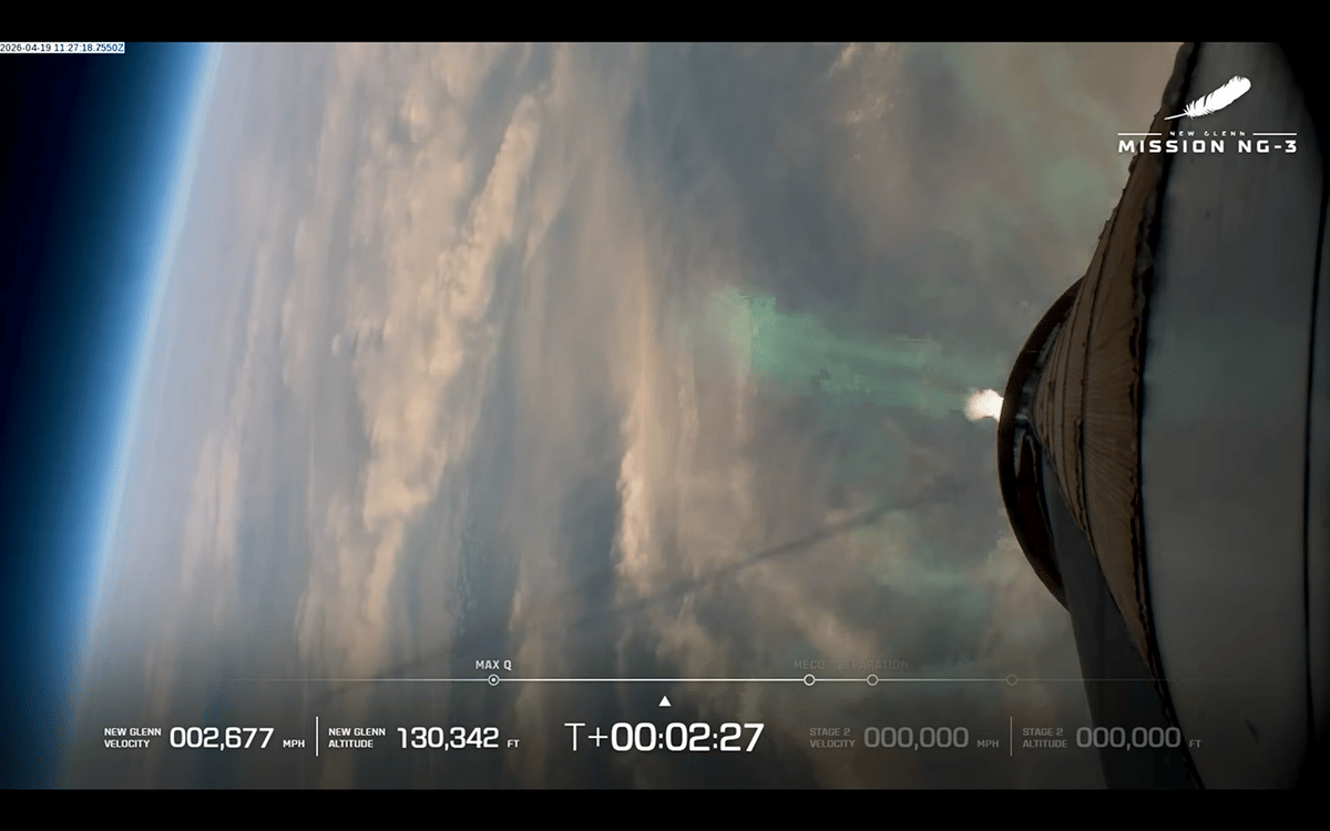 A view of Earth during the launch of Blue Origin's NG-New Glenn rocket as seen from the booster. The shadow of its exhaust plume is visible across the left side of the image.