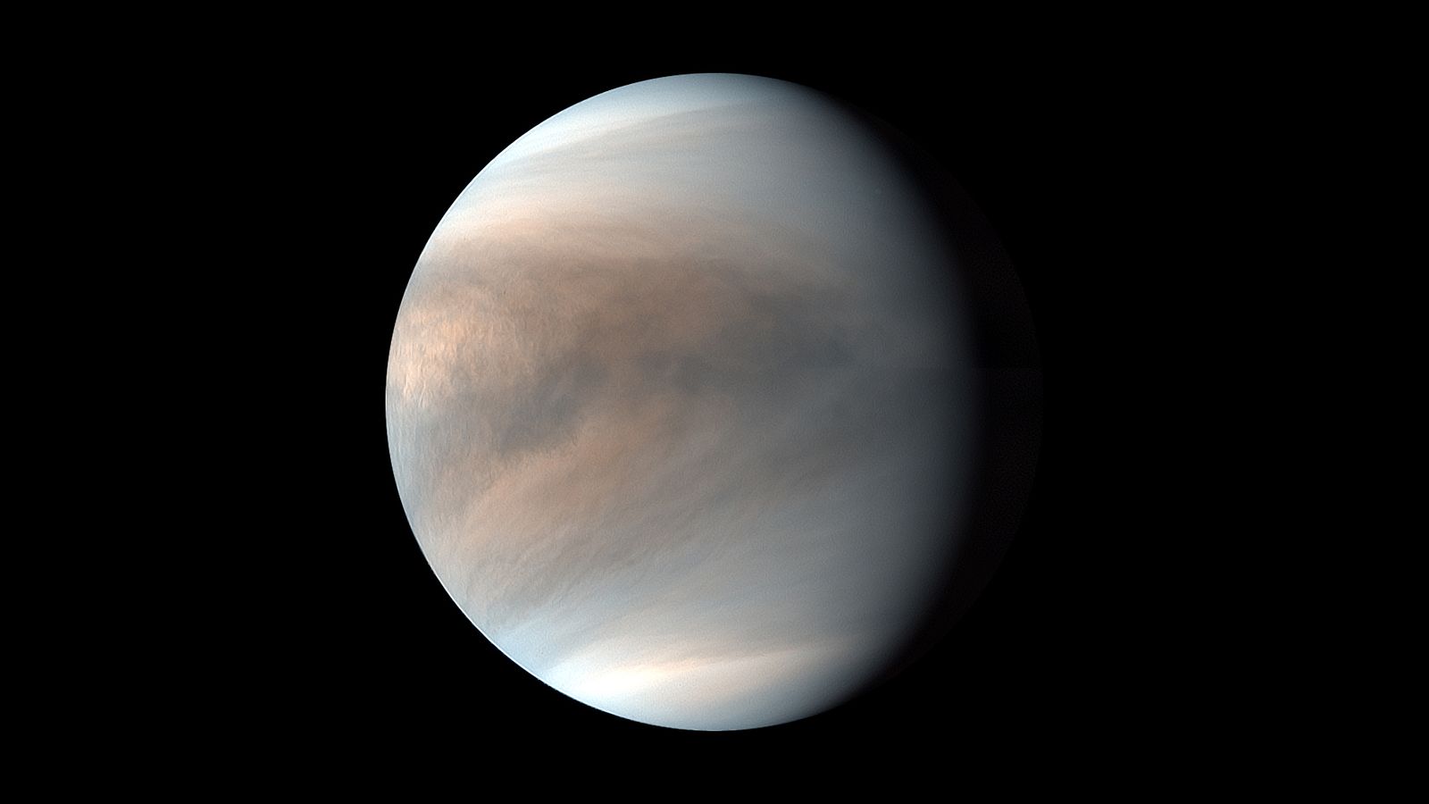 spacecraft photo of a cloudy, gray-and-tan-banded planet