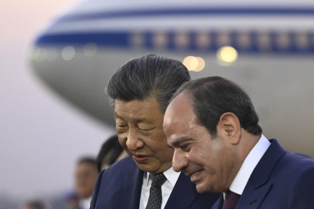 Photo by KHALED DESOUKI / POOL / AFP  China's President Xi Jinping (L) listens to his Egyptian counterpart Abdel Fattah al-Sisi upon his arrival at the Cairo International Airport on September 1, 2026.