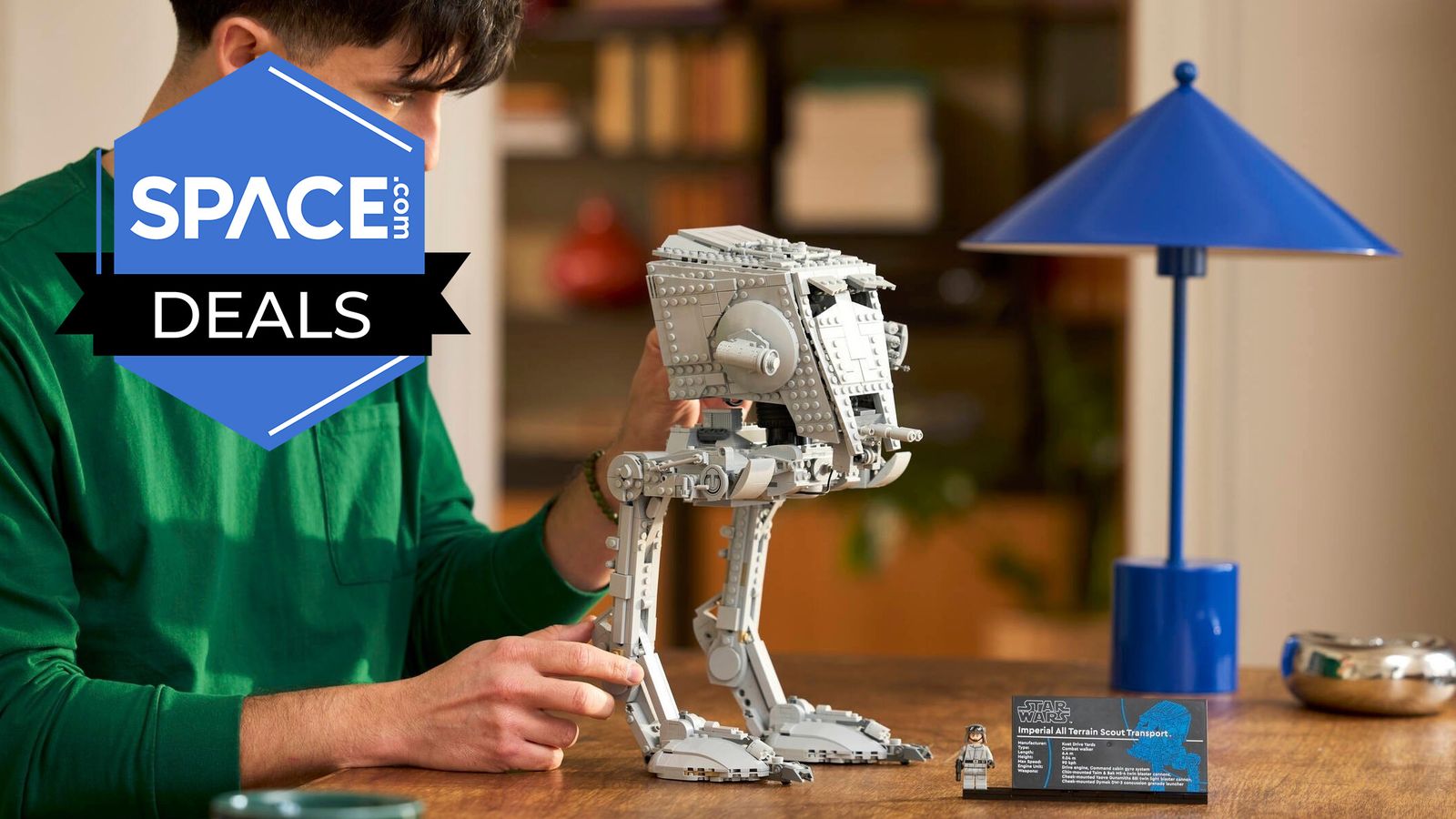 A Lego Star Wars AT-ST Walker 75417 being held on a table.