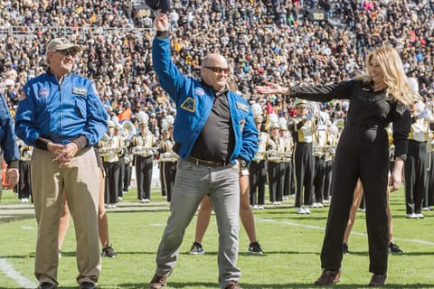 Scott Tingle waves to the crowd at Ross-Ade Stadium during a celebration in 2019 where Purdue recognized the astronaut alumni in attendance for the football game that day