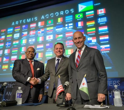 NASA Deputy Administrator Matt Anderson, center, Ambassador of Djibouti to the United States, Mohamed Siad Douale, left, and Assistant Secretary of State for African Affairs, Frank Garcia, right, pose for a group photograph after the Artemis Accord signing, Monday, September 14, 2026, at the Mary W. Jackson NASA Headquarters building in Washington. Djibouti is the 72nd country to sign the Artemis Accords, which establish a practical set of principles to guide space exploration cooperation among