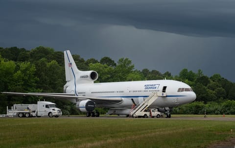 An airplane with a rocket attached to its belly