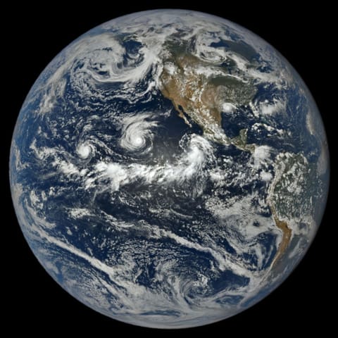 In a full-disk satellite view of Earth, three tropical cyclones—named Lowell, Karina, and Marie—swirl above the blue waters of the Pacific Ocean and to the west of Central America.