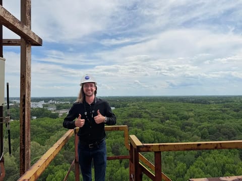 Jaden Caradine standing atop the gantry at NASA Langley's Impact Dynamics Facility