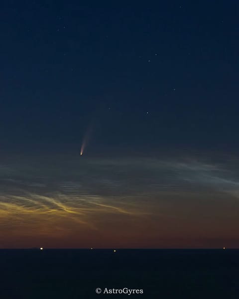 A light brown dust plume, dense at its center and more diffuse toward its edges, extends horizontally across an orange-brown and green landscape. Scattered white clouds cover some of the scene.