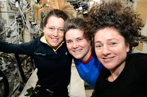 From left, Expedition 75 crew members Sophie Adenot of ESA (European Space Agency) and Anna Kikina of Roscosmos, both flight engineers, and International Space Station commander Jessica Meir of NASA gather together for a portrait inside the Kibo laboratory module.