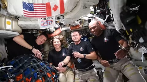 The four Artemis II crew members participate in a live downlink on flight day six, following the conclusion of their lunar flyby.