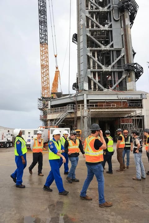 Artemis III crew members inspecting the Starship launch tower structure at Kennedy Space Center