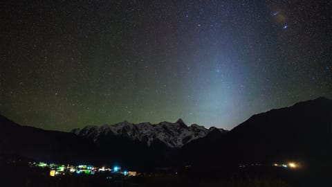 Meteor and zodiacal light above the Himalayas.