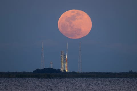 This image shows NASA’s SLS (Space Launch System) and Orion spacecraft rolling out of the Vehicle Assembly Building at NASA’s Kennedy Space Center. NASA's massive Crawler-Transporter, upgraded for the Artemis program, carries the powerful SLS rocket and Orion spacecraft on the Mobile Launcher from the Vehicle Assembly Building to Launch Pad 39B at Kennedy Space Center in preparation for the Artemis II mission.