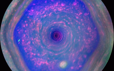 a blue swirling hexagon on a grey orb