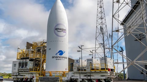 An Amazon Leo satellite standing upright at a space center