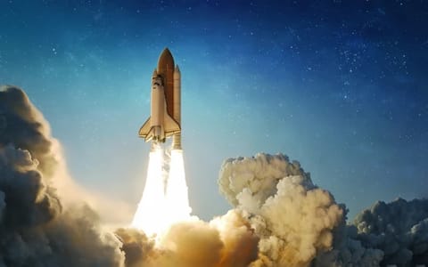 Space shuttle flight from Earth surface into space. The spacecraft in a cloudy night sky. The launch of rocket carrying astronauts into outer space. Elements of this image furnished by NASA. Not AI.