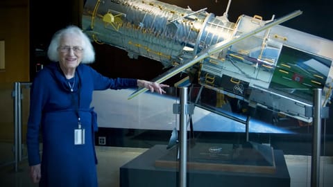 Nancy Grace Roman stands next to a scale model of the Hubble Space Telescope outside the Hubble control center at NASA’s Goddard Space Flight Center in Greenbelt, Maryland. Roman is known as the “Mother of Hubble.” Image: NASA