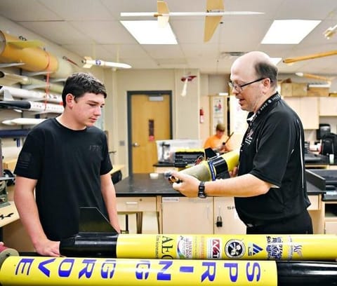 Student Micah Henning, 16, left, and science teacher Brian Hastings discuss materials as they examine segments of a rocket during a club meeting at Spring Grove Area High School in Jackson Township on Thursday, Aug. 27, 2026. The team placed 21st in the...