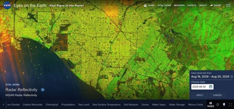 An image from above the Los Angeles metro area as seen in Eyes on the Earth with NISAR radar reflectivity data that is in bright colors of green, yellow, red and orange.