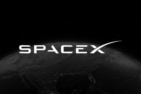 SpaceX logo in white over a dark, partially lit Earth seen from space