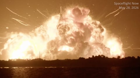 a massive fireball can be seen over a distant treeline