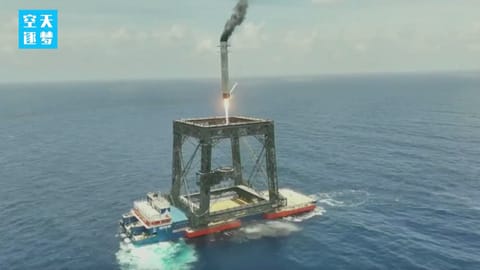 The first stage of a Chinese Long March 10B rocket comes down for a landing at sea after successfully sending a satellite to orbit on July 10, 2026.