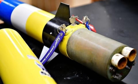 The segmented parts of a rocket are examined during a rocket club meeting at Spring Grove Area High School in Jackson Township on Thursday, Aug. 27, 2026.