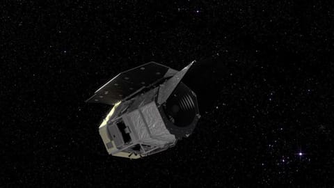 A visualization of a silvery spacecraft in a starry section of space.