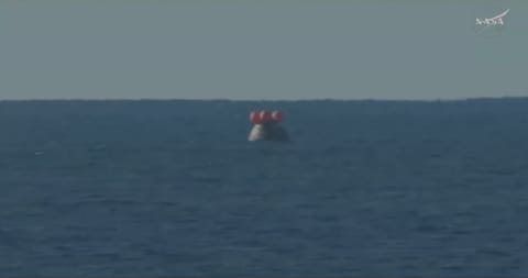 The Orion spacecraft with the Artemis II crew inside is seen floating in the Pacific Ocean after splashing down at 8:07 p.m. EDT on April 10, 2026.