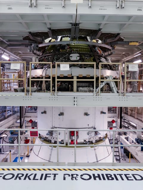 Orion spacecraft in an industrial high bay.