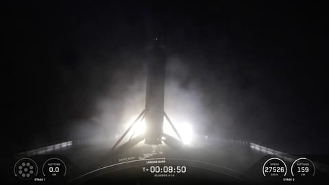 The first stage of a SpaceX Falcon 9 rocket rests on the deck of a ship at sea shortly after launching three AST SpaceMobile BlueBird satellites on June 17, 2026.
