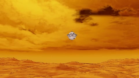 A spherical silver spacecraft against a fiery orange background