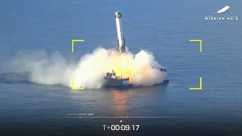 a white rocket lands on a ship at sea during the daytime