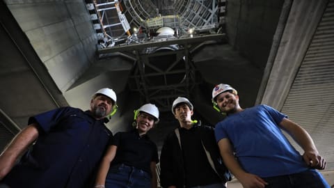 Employees pose for a photograph following work inside the VAB to secure the left-hand aft assembly solid rocket booster segment to the mobile launcher at the VAB on July 9, 2026.