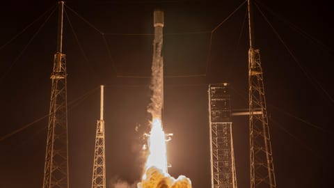 rocket launching from a launch pad at night