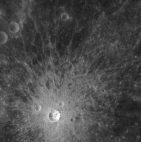 A rough grey surface with circular indentations
