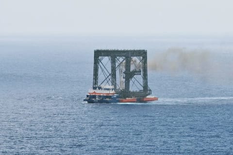 The returned first stage of a China's Long March-10B carrier rocket is successfully captured on a seaborne platform via a net-capture system on July 10, 2026.